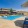 Large sparkling blue pool with a large pool deck and lounge chairs